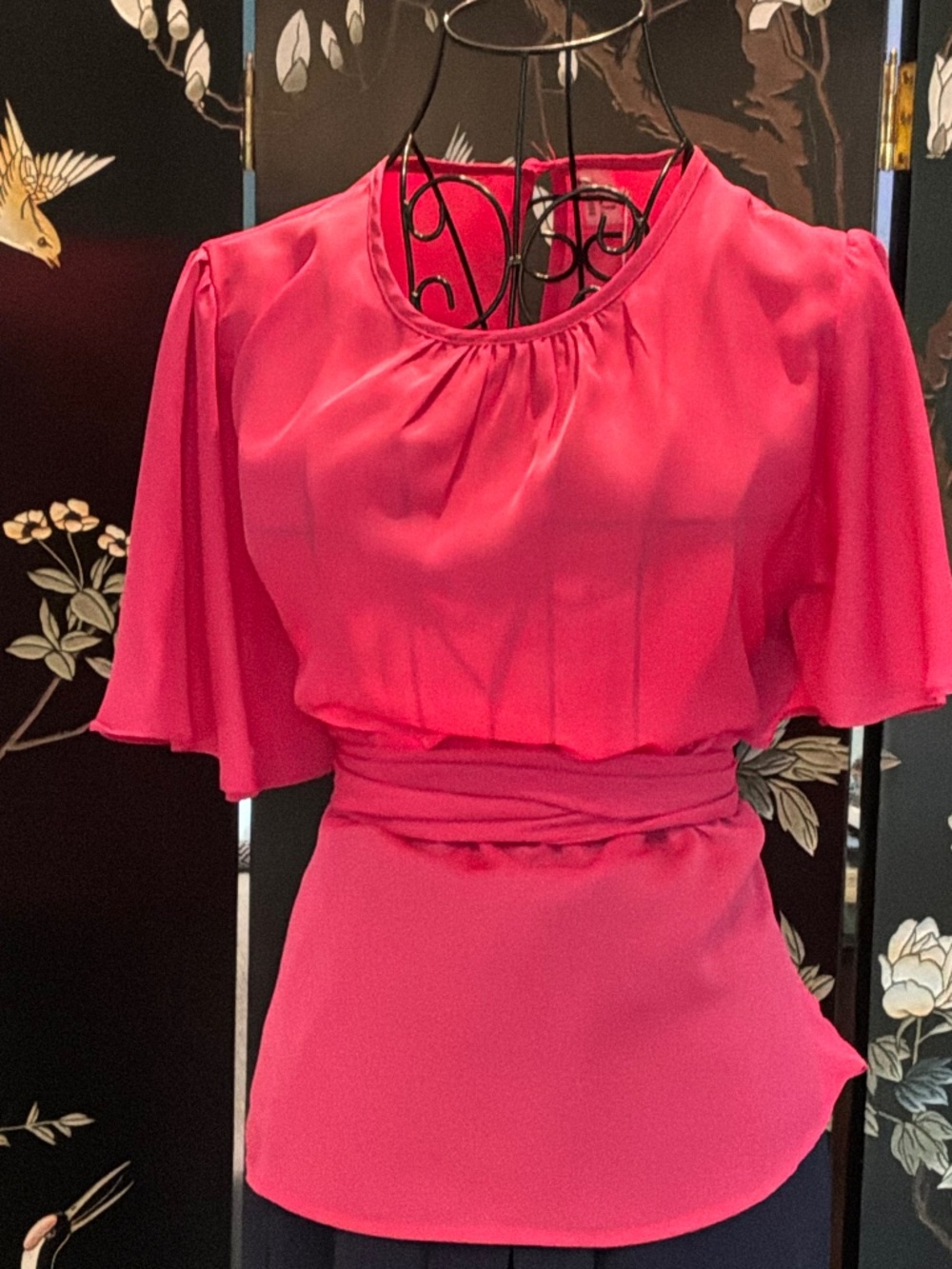 Catherine’s hot pink cinched blouse with extra long sash